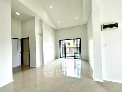 Spacious modern living room with high ceilings and large windows