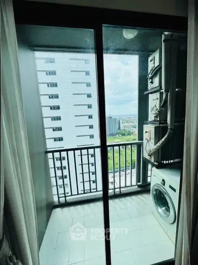 High-rise apartment balcony with city view and washing machine