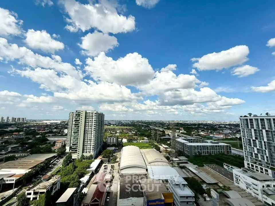 Stunning cityscape view from high-rise building with blue sky and clouds