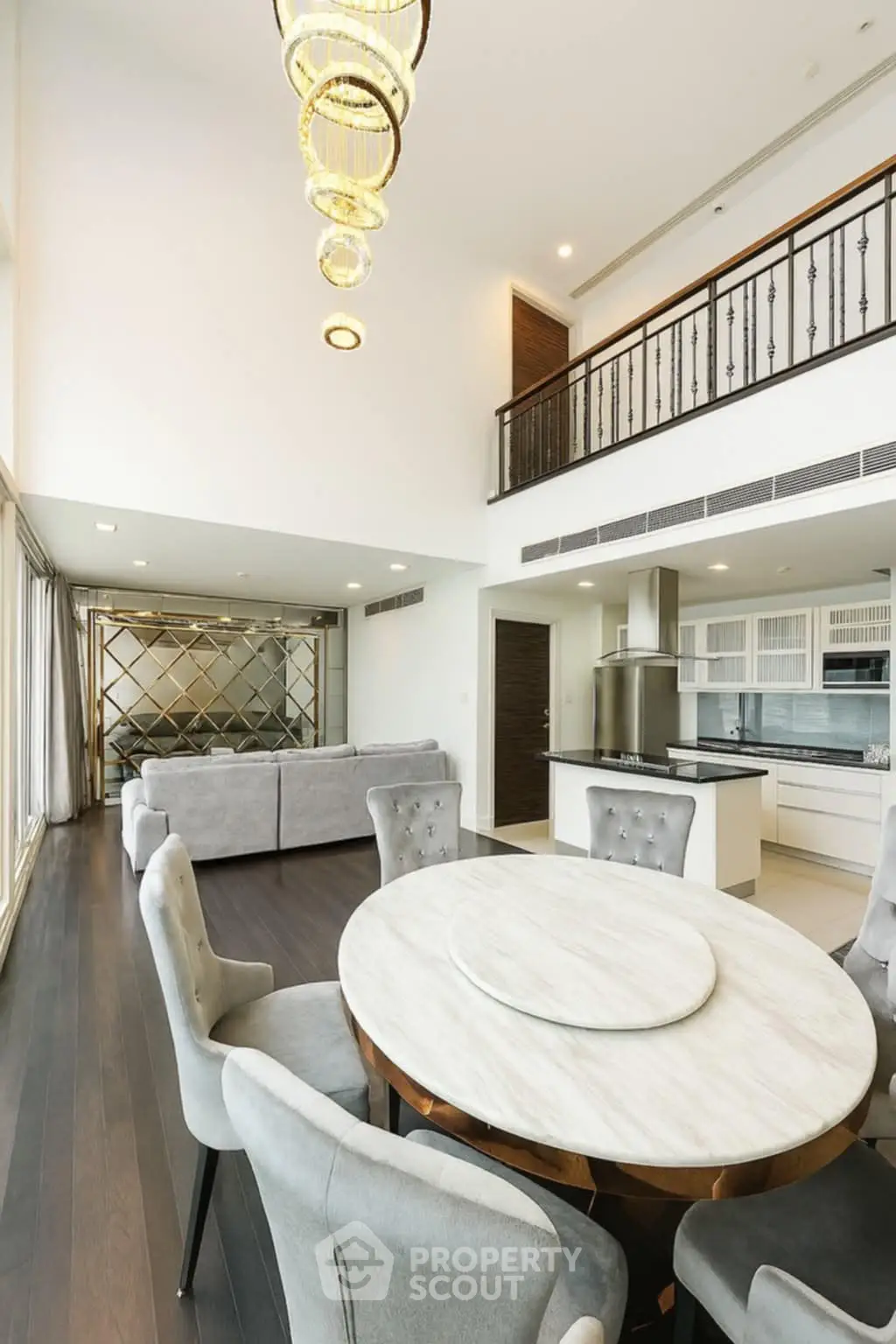 Luxurious open-plan living room with elegant dining area and modern kitchen in a high-end apartment.