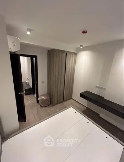 Modern bedroom with sleek design and minimalist furniture in a cozy apartment.