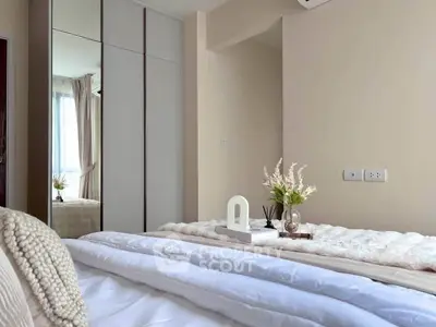 Cozy bedroom with elegant decor and large mirrored wardrobe, perfect for modern living.