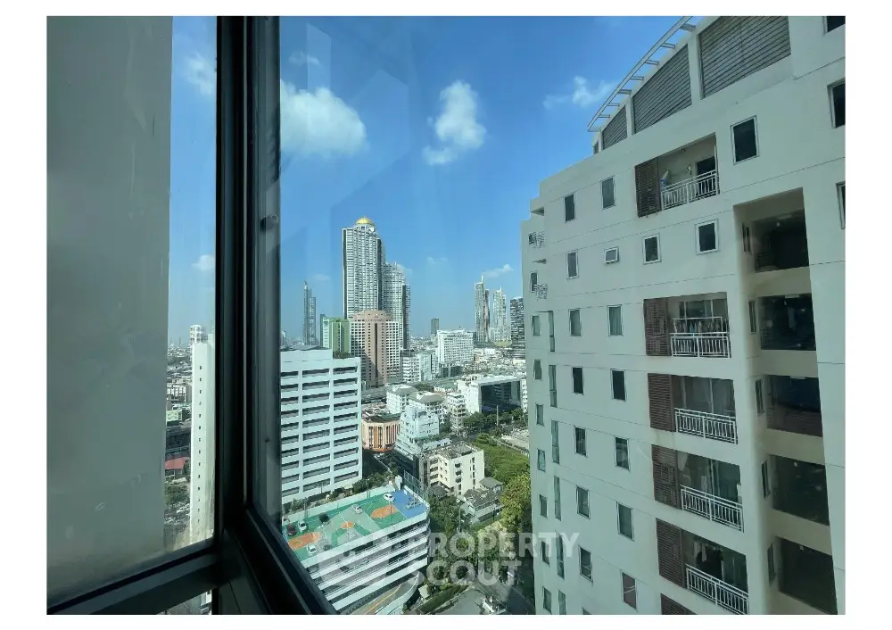 Stunning cityscape view from high-rise apartment window in urban setting