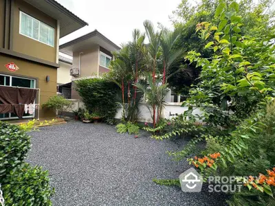 Charming garden view of modern home with lush greenery and spacious outdoor area.