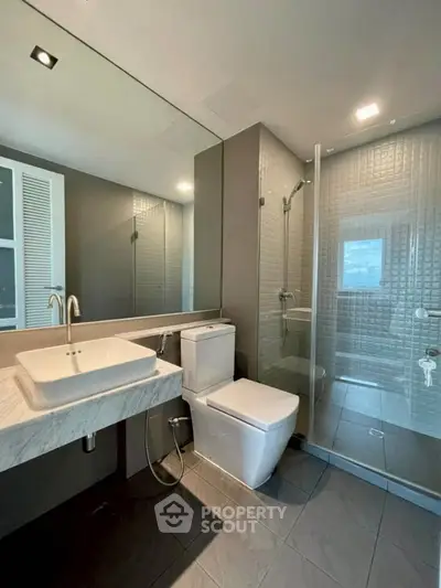 Modern bathroom with sleek fixtures and glass shower enclosure