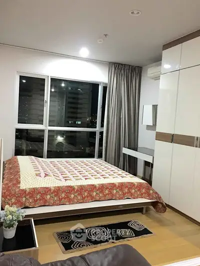 Modern bedroom with large window and stylish decor in urban apartment