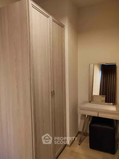 Stylish bedroom corner with wardrobe and vanity in modern apartment