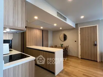 Modern kitchen with open layout and dining area in stylish apartment