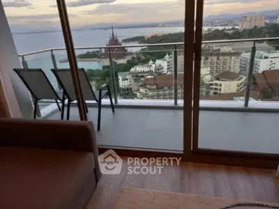 Stunning high-rise balcony with breathtaking ocean and city views, perfect for relaxation.