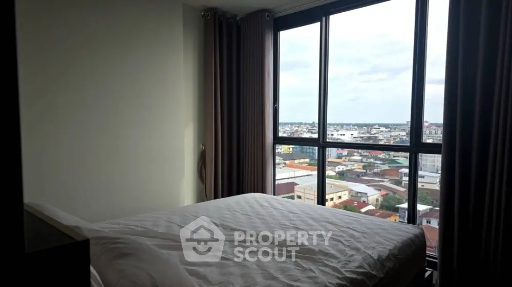 Modern bedroom with panoramic city view from large windows