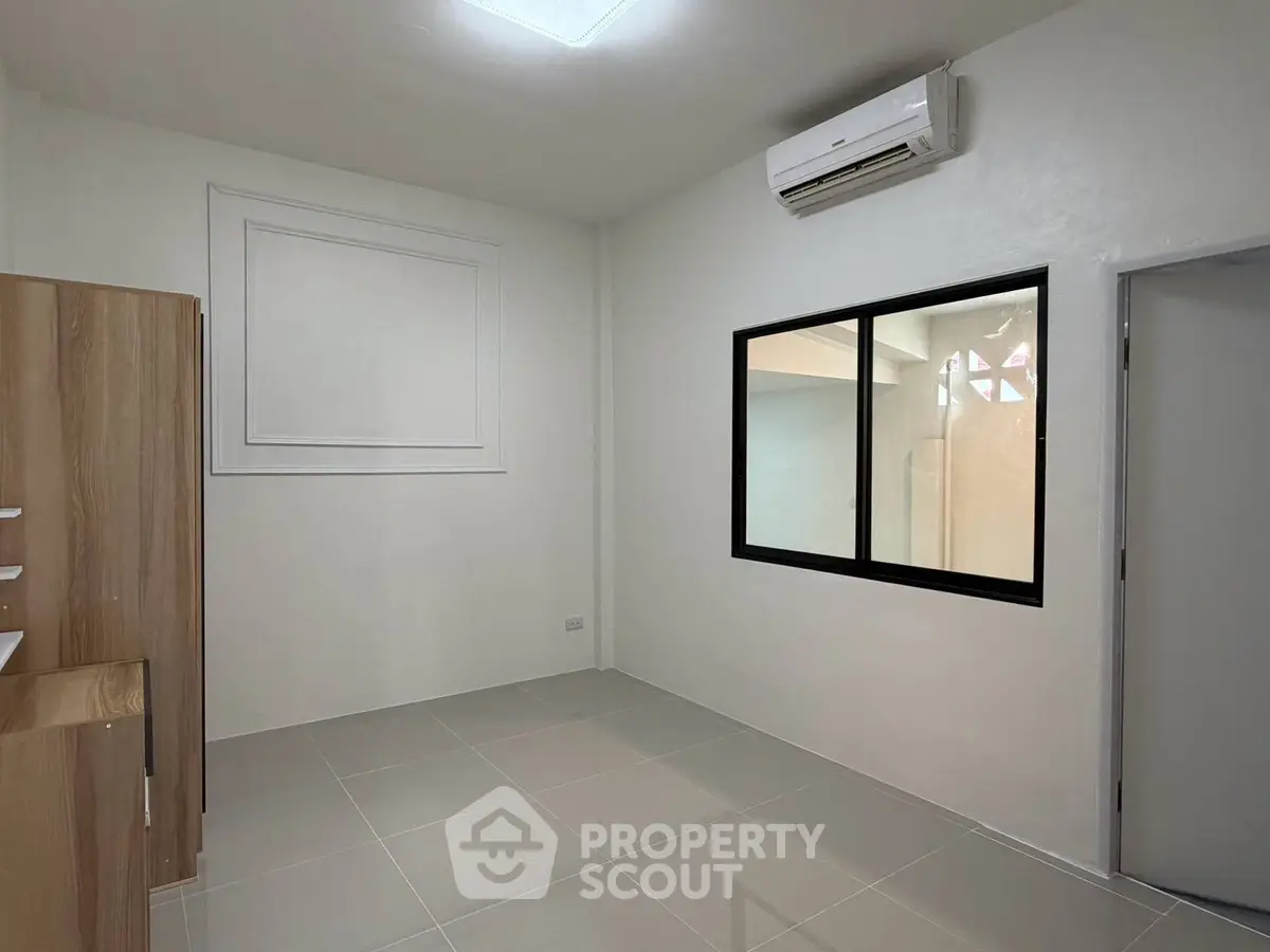 Minimalist room with air conditioning and tiled floor, perfect for a cozy living space.