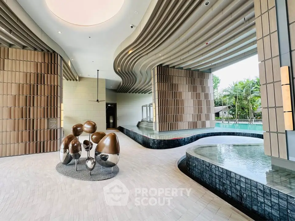 Luxurious modern pool area with unique architectural design and artistic sculptures.