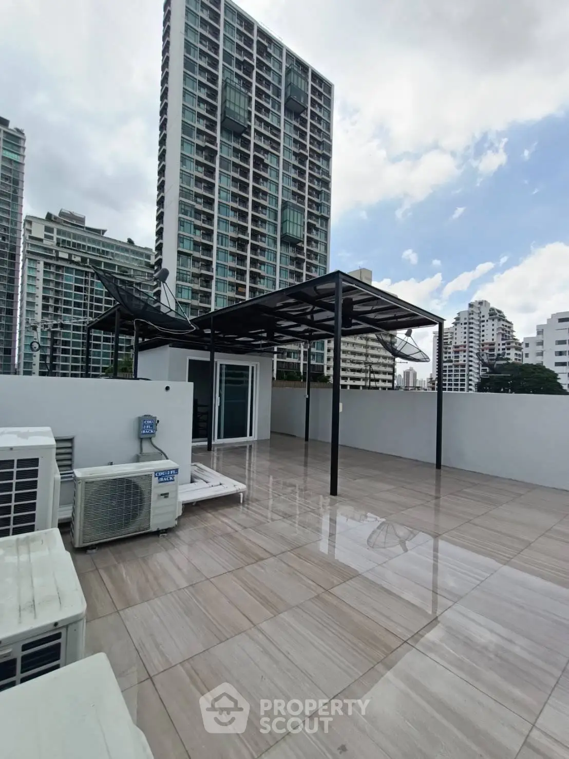Spacious rooftop with modern pergola and city skyline views