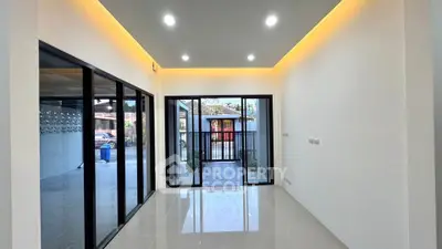 Modern living room with sleek glass doors and ambient lighting