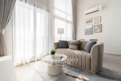 Elegant living room with modern sofa, stylish decor, and abundant natural light.
