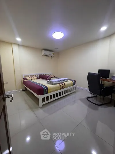 Spacious bedroom with modern furnishings and ample lighting, perfect for comfort and relaxation.