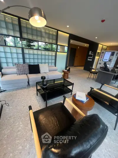 Modern living room with stylish furniture and large windows in a contemporary apartment.