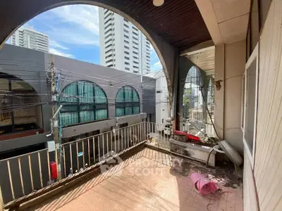 Spacious balcony with urban view in high-rise building, perfect for city living enthusiasts.
