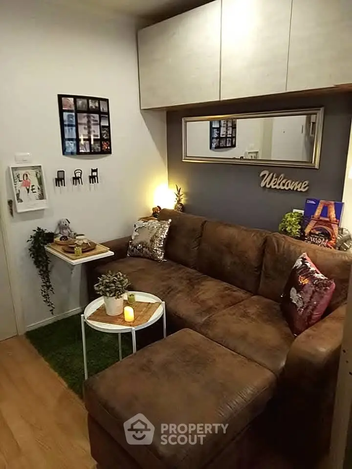Cozy living room with brown sectional sofa, decorative pillows, and wall art for a welcoming ambiance.