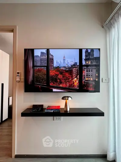 Modern living room with wall-mounted TV and sleek shelf, showcasing a stylish interior design.