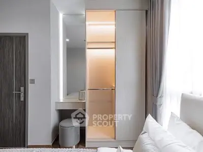 Modern bedroom with sleek closet and cozy vanity area