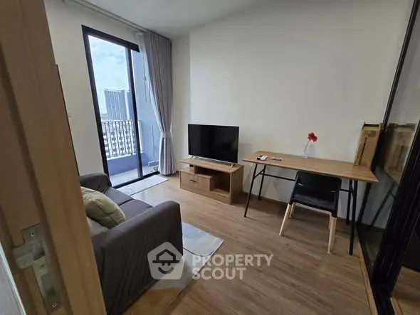 Modern living room with balcony view, sleek furniture, and natural light.