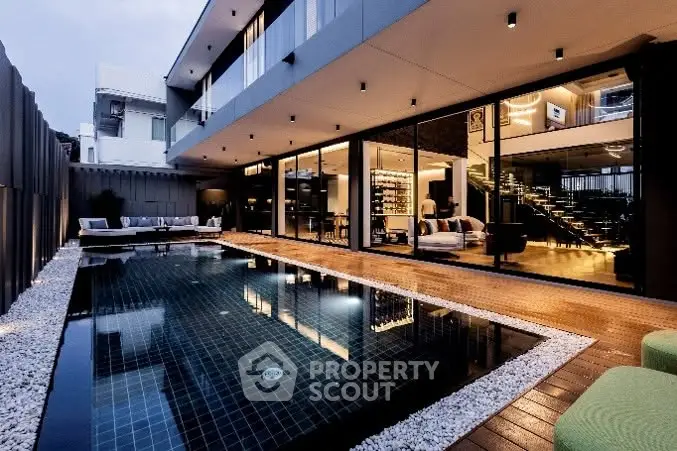 Luxurious modern home with stunning pool and elegant outdoor lighting