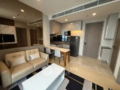 Modern open-plan living room and kitchen with sleek design and neutral tones.
