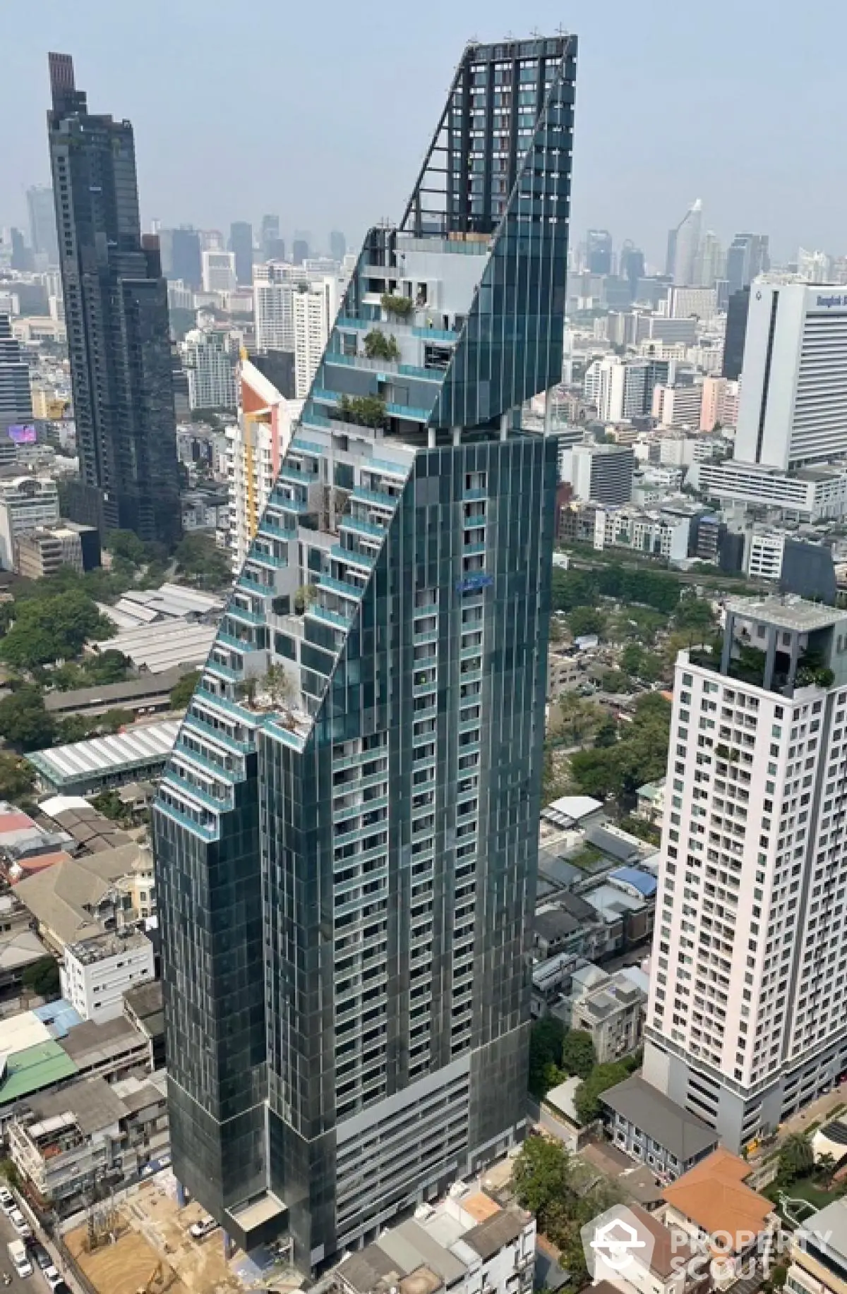 Stunning modern skyscraper with unique architecture in bustling cityscape