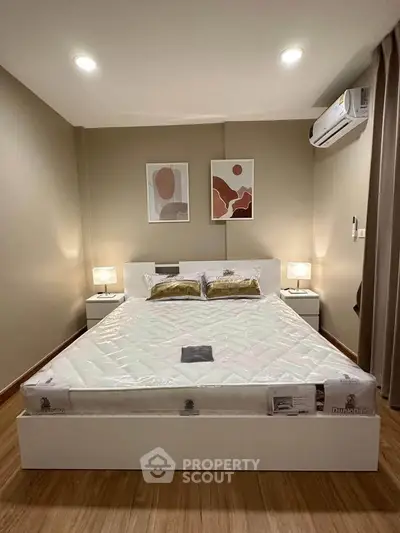 Modern bedroom with stylish decor and air conditioning in a cozy apartment.