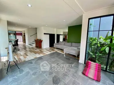 Spacious modern living room with stylish decor and large windows for natural light.