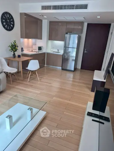 Modern open-plan living room with sleek kitchen and stylish decor