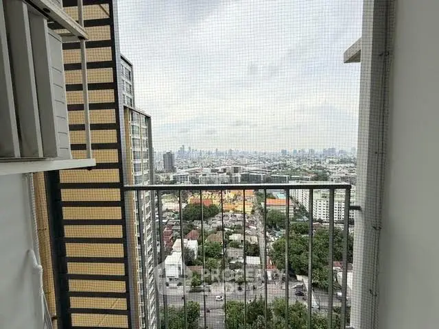 Stunning cityscape view from high-rise balcony with urban skyline.