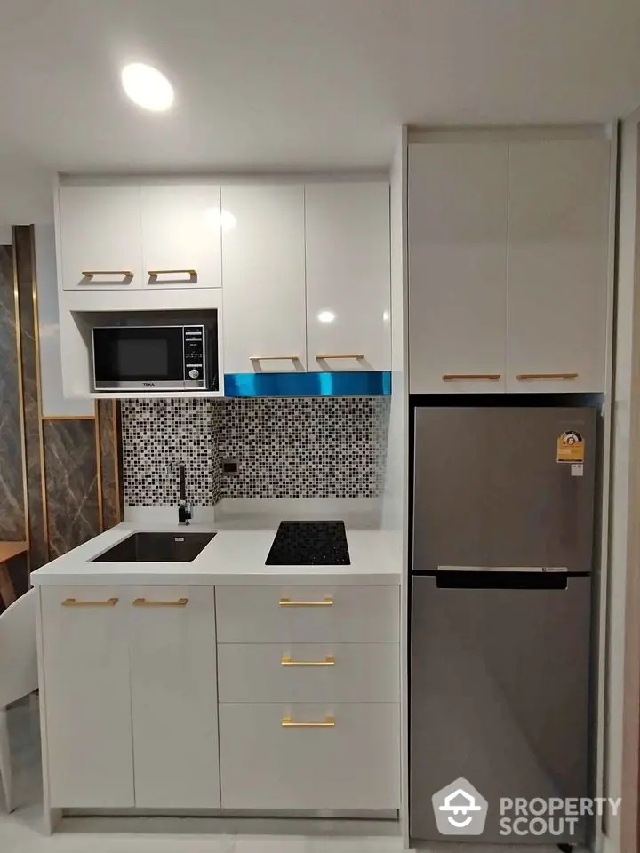 Modern kitchen with sleek white cabinets and built-in appliances