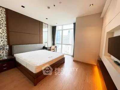 Spacious modern bedroom with city view and elegant decor