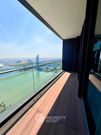 Stunning high-rise balcony with breathtaking city and river views, perfect for relaxation and enjoying the skyline.