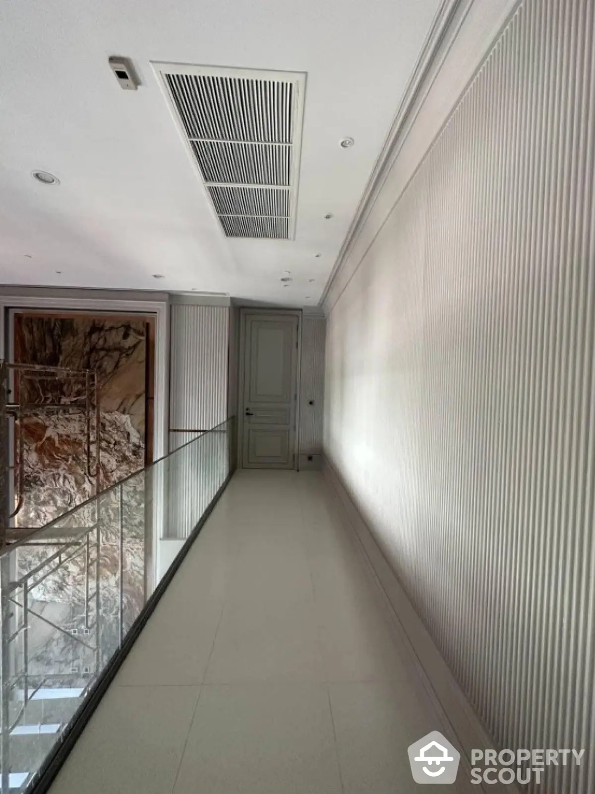 Elegant hallway with modern design and glass railing in luxury property