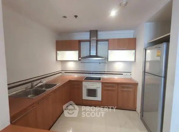 Modern kitchen with wooden cabinets and stainless steel appliances