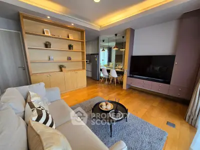 Modern living room with stylish decor and open layout, featuring cozy seating and elegant shelving.
