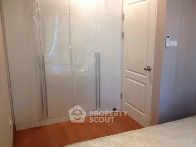 Modern bedroom with sleek wardrobe and wooden flooring
