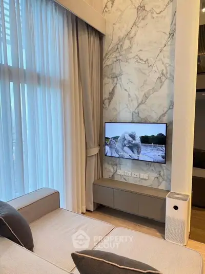 Modern living room with marble accent wall and stylish furniture