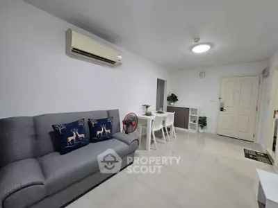 Modern living room with sleek furniture and air conditioning, perfect for comfortable living.