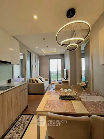 Modern open-plan living room with stylish lighting and cozy decor