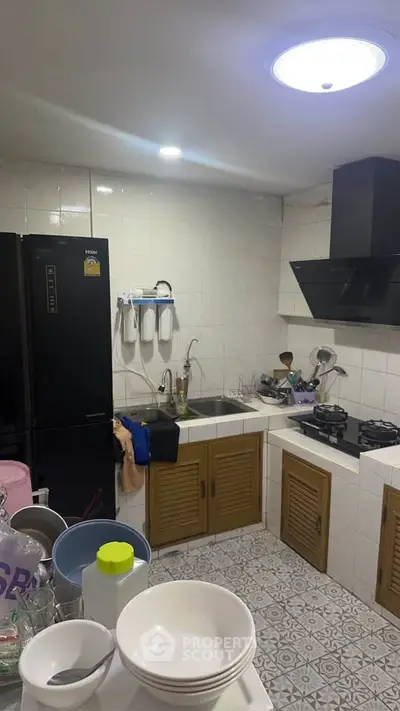 Cozy kitchen with modern appliances and tiled flooring, featuring a gas stove and ample storage space.