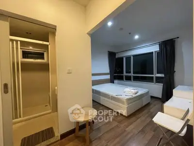 Modern bedroom with ensuite bathroom and large windows for natural light.