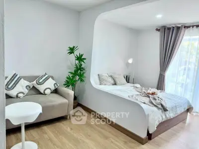 Modern studio apartment with cozy bed and stylish living area