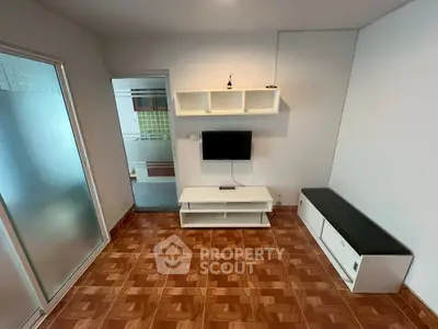 Cozy living room with modern TV setup and stylish tile flooring