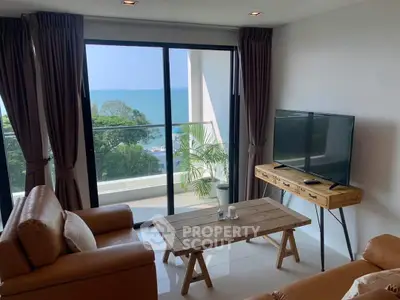 Stunning living room with ocean view and modern furnishings, perfect for relaxation and entertainment.