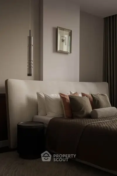 Luxurious bedroom with elegant decor and plush bedding in a modern apartment.