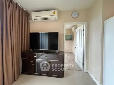 Modern living room with sleek TV cabinet and air conditioning in a stylish apartment.